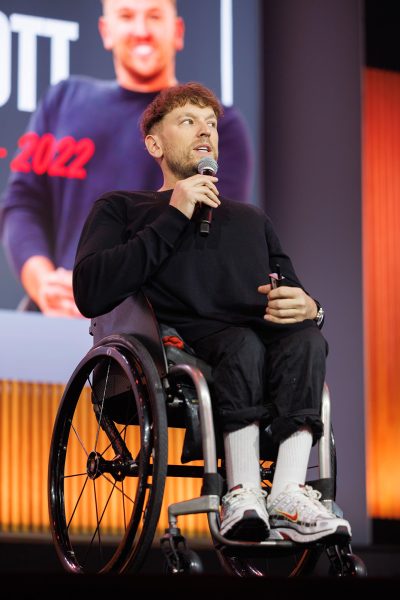 Dylan Alcott speaking on a stage