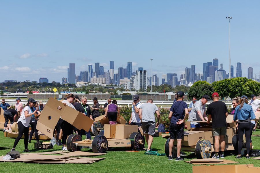 Outdoor team building at Flemington Racecourse with Melbourne city in background