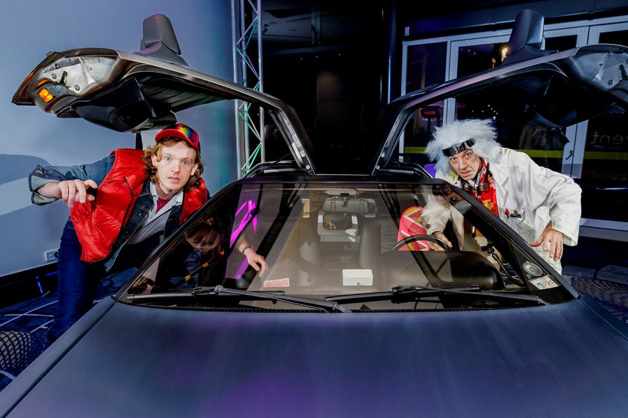 Back to the Future characters posing with a delorean