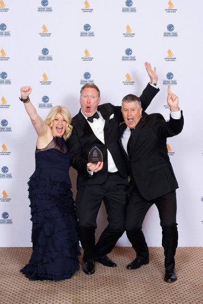 Award winners in front of a media wall